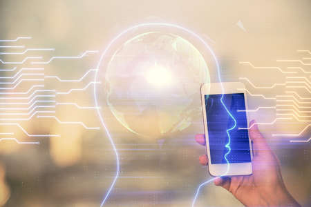 Double exposure of brain sketch hologram and woman holding and using a mobile device.の写真素材