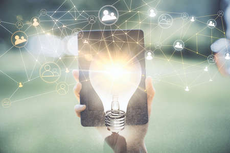 Double exposure of social network sketch hologram and woman holding and using a mobile device.の写真素材