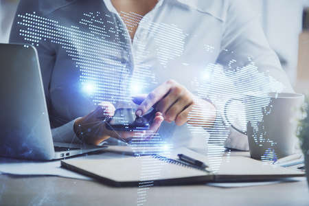 Double exposure of social network sketch hologram and woman holding and using a mobile device.