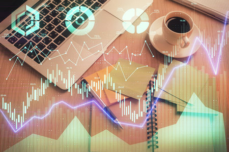 Stock market graph and top view computer on the table background. Double exposure. Concept of financial education.の写真素材