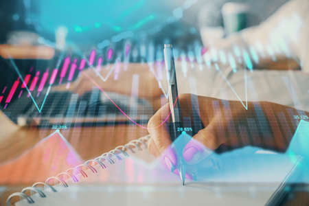 Double exposure of forex chart drawing over people taking notes background. Concept of financial analysisの写真素材