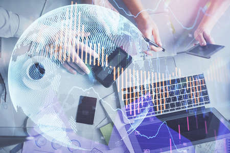 Double exposure of man and woman working together and financial chart hologram drawing. market...