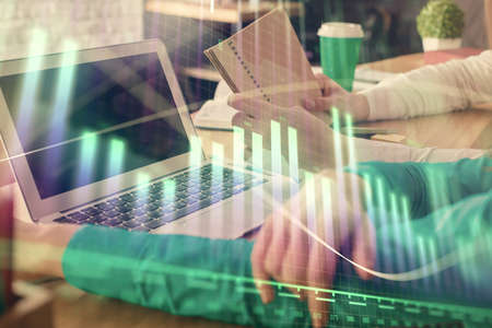 Double exposure of man and woman working together and forex chart hologram. Business concept....