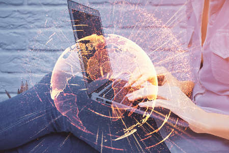 Double exposure of woman hands typing on computer and social network theme hologram drawing. People media concept.の写真素材