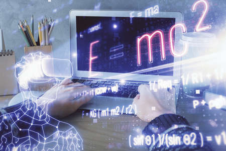 Double exposure of woman hands typing on computer and formula hologram drawing. Education concept.の写真素材