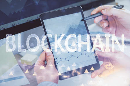 Double exposure of mans hands holding and using a phone and crypto currency blockchain theme drawing.の写真素材