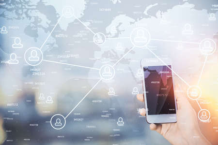 Double exposure of social network sketch hologram and woman holding and using a mobile device.の写真素材