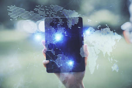 Double exposure of social network sketch hologram and woman holding and using a mobile device.の写真素材