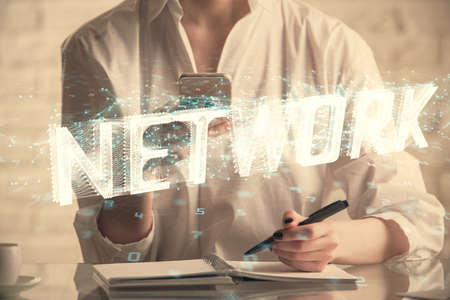 Double exposure of technology sketch hologram and woman holding and using a mobile device. Ai conceptの写真素材