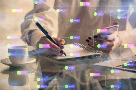 Double exposure of technology sketch hologram and woman holding and using a mobile device. Ai...