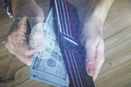 Multi exposure of fingerprint drawing hologram and USA dollars bills and man hands. security concept.の写真素材