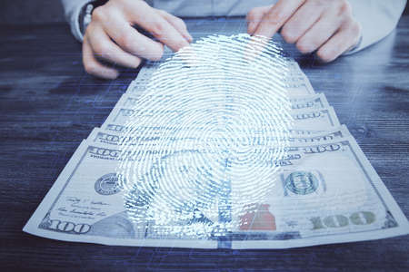 Multi exposure of fingerprint drawing hologram and USA dollars bills and man hands. security concept.の写真素材