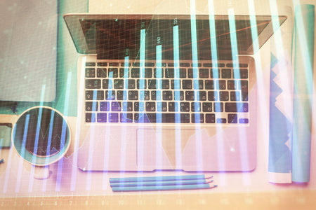 Double exposure of forex graph drawing over desktop background with computer. Concept of financial analysis. Top view.の写真素材