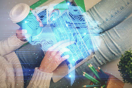 Double exposure of woman hands working on computer and brain hologram drawing. Ai concept.