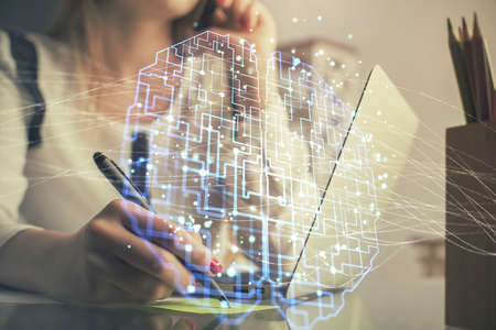 Multi exposure of woman hands working on computer and human brain hologram drawing. Ai tech concept.