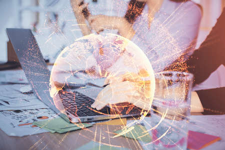 Double exposure of woman hands typing on computer and social network theme hologram drawing. People media concept.の写真素材