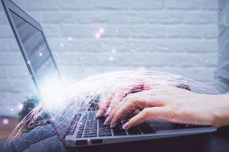 Double exposure of woman hands typing on computer and social network theme hologram drawing. People...