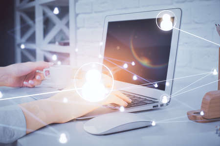Double exposure of woman hands typing on computer and social network theme hologram drawing. People media concept.の写真素材