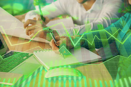 Double exposure of forex chart drawing over people taking notes background. Concept of financial...