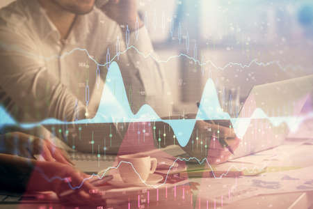 Multi exposure of man and woman working together and financial chart hologram. Business concept....