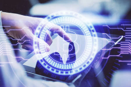 Double exposure of mans hands holding and using a phone and crypto currency blockchain theme...