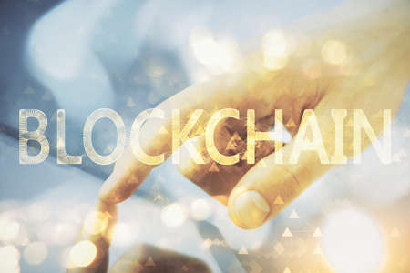 Double exposure of mans hands holding and using a phone and crypto currency blockchain theme drawing.の写真素材