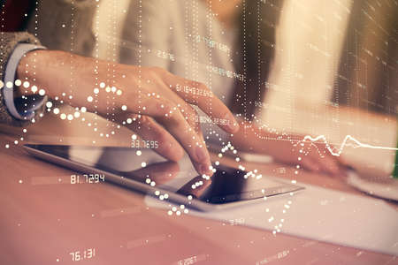 Double exposure of data theme hologram drawing and man and woman working together holding and using a mobile device.の写真素材