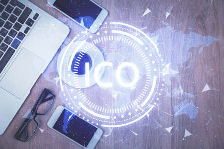 Double exposure of blockchain theme hologram over table with phone. Top view. Crypto technology concept.の写真素材