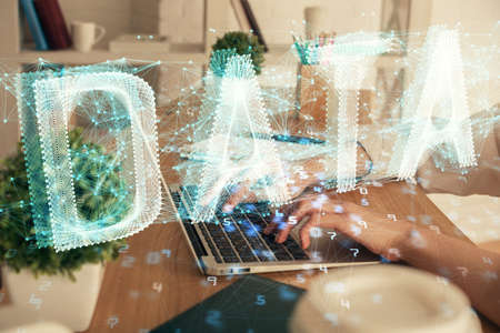 Double exposure of woman hands working on computer and data theme hologram drawing. Tech concept.
