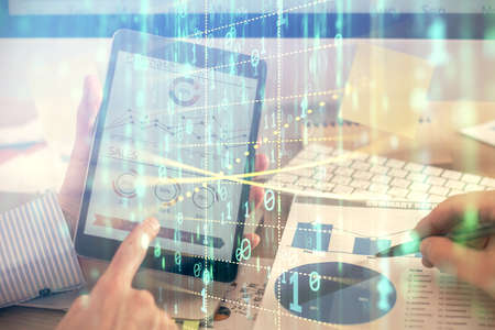 Multi exposure of mans hands holding and using a digital device and data theme drawing. Innovation...