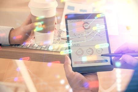 Multi exposure of mans hands holding and using a digital device and data theme drawing. Innovation...
