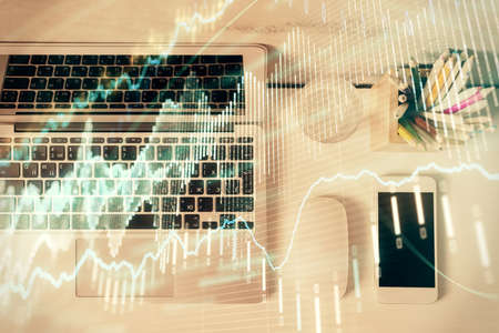 Multi exposure of forex graph drawing over desktop background with computer. Concept of financial...