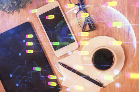 Double exposure of technology theme drawing over work table desktop. Top view. Global data analysis...
