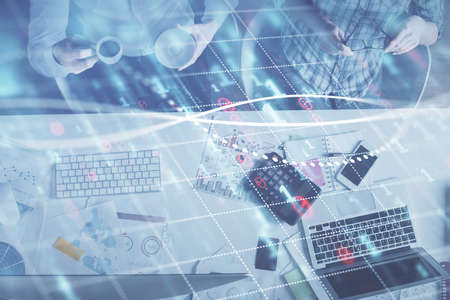 Double exposure of man and woman working together and financial chart hologram drawing. market...