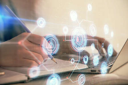 Multi exposure of woman hands working on computer and data theme hologram drawing. Tech concept.の写真素材