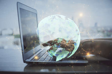 Double exposure of woman hands typing on computer and social network theme hologram drawing. People...
