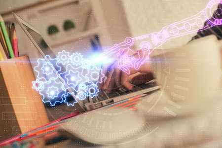 Double exposure of woman hands working on computer and data theme hologram drawing. Tech concept.の写真素材