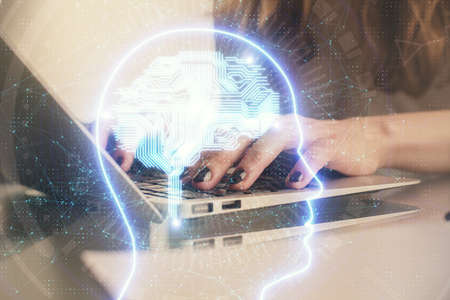 Double exposure of woman hands working on computer and brain hologram drawing. Ai concept.