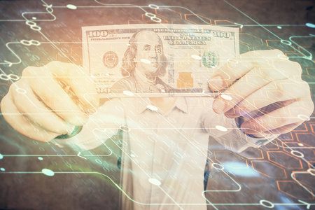Double exposure of technology drawing hologram and us dollars bills and man hands. Data conceptの写真素材