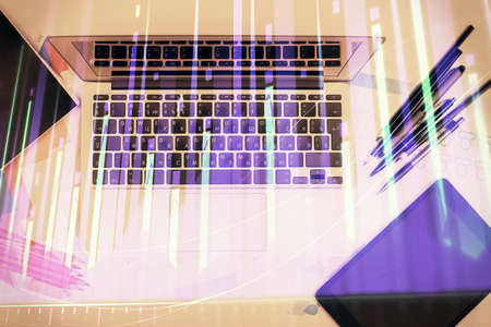 Multi exposure of forex chart drawing over table background with computer. Concept of financial research and analysis. Top view.の写真素材