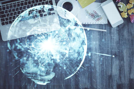 Business theme hologram drawings over computer on the desktop background. Top view. Multi exposure. Concept of international connections.の写真素材