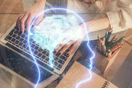 Double exposure of woman hands working on computer and brain hologram drawing. Ai concept.