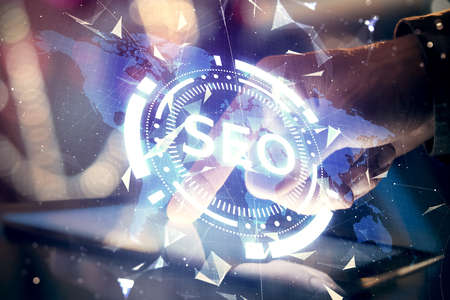 Multi exposure of mans hands holding and using a digital device and seo drawing. search optimization concept.の写真素材