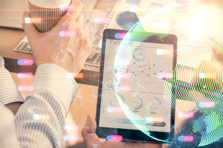 Multi exposure of mans hands holding and using a digital device and map drawing. International...