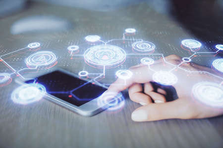 Double exposure of social network sketch hologram and woman holding and using a mobile device.