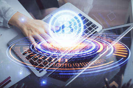 Double exposure of woman hands typing on computer and crypto market theme hologram drawing....