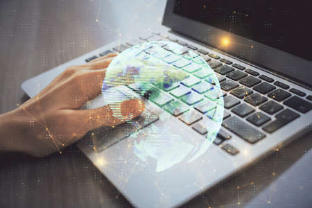 Double exposure of woman hands typing on computer and social network theme hologram drawing. People media concept.の写真素材