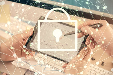 Multi exposure of mans hands holding and using a digital device and lock drawing. Security concept.
