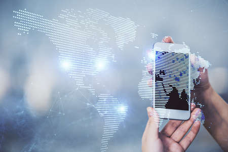 Double exposure of social network sketch hologram and woman holding and using a mobile device.の写真素材