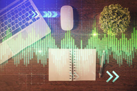 Stock market graph and top view computer on the table background. Double exposure. Concept of...